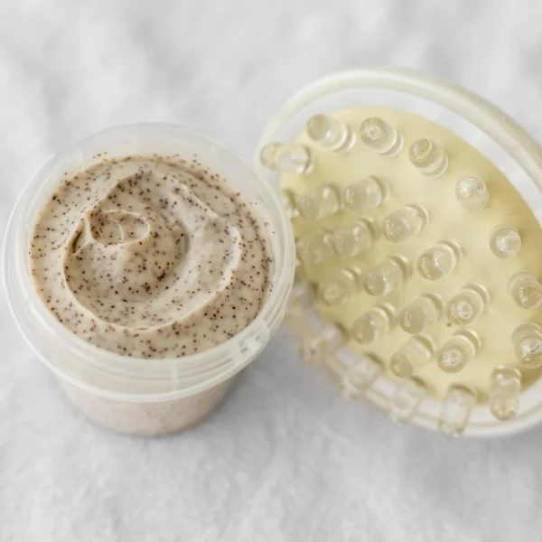A bowl of cream next to a tube of toothpaste on a countertop, highlighting contrasting personal care items.