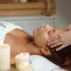 A woman receiving a facial massage at a spa in Saint-Hyacinthe, surrounded by calming decor and soft lighting.